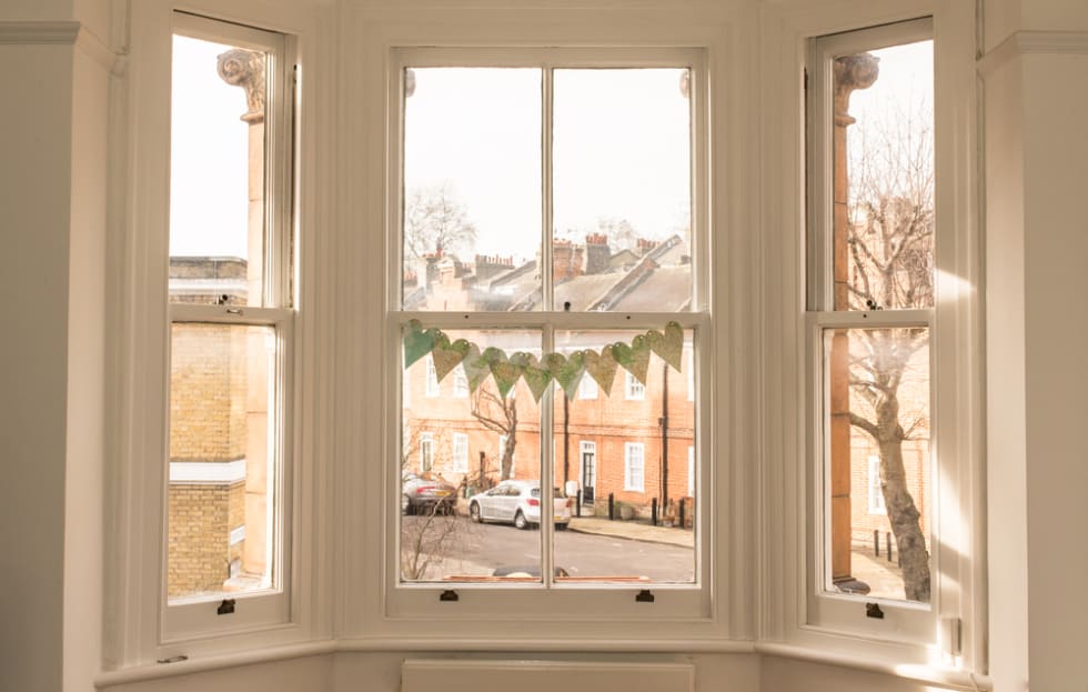 Interior of a classic victorian British house with old victorian windows facing a characteristic British mews.