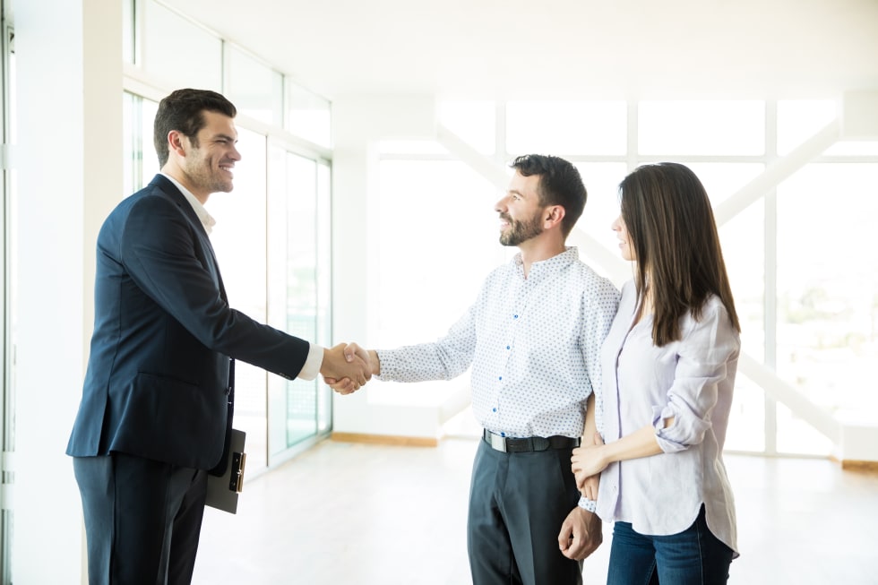 estate agent congratulating to couple for buying new house - landlord showing tips