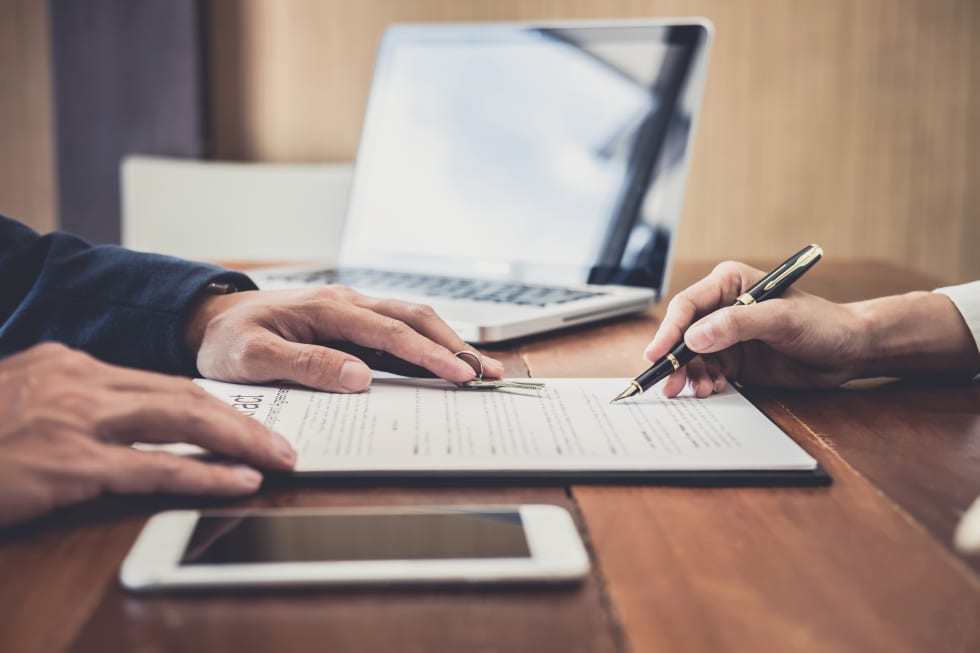 Sales manager filing keys to customer after signing rental lease contract of sale purchase agreement, concerning mortgage loan offer for and house insurance - rent increase laws