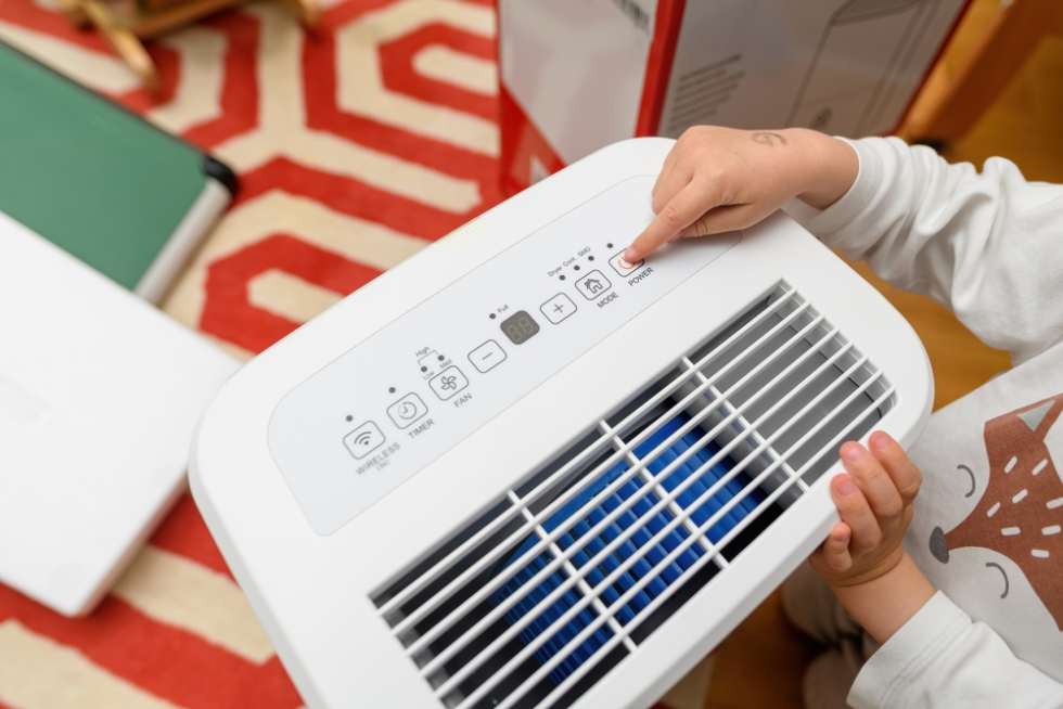 Toddler's hand pointing to dehumidifier