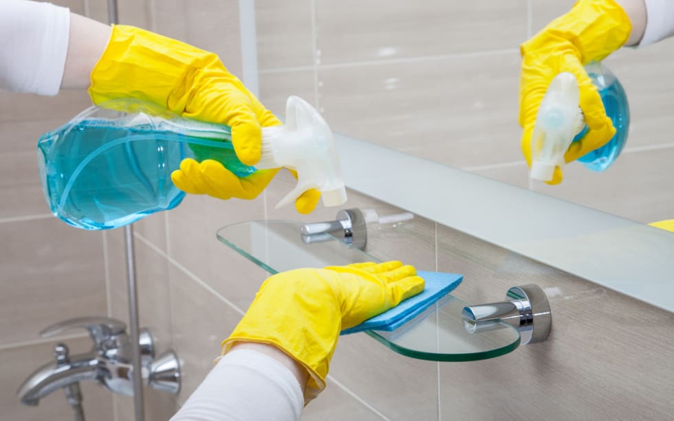 Housemaid cleaning a bathroom, closeup shot