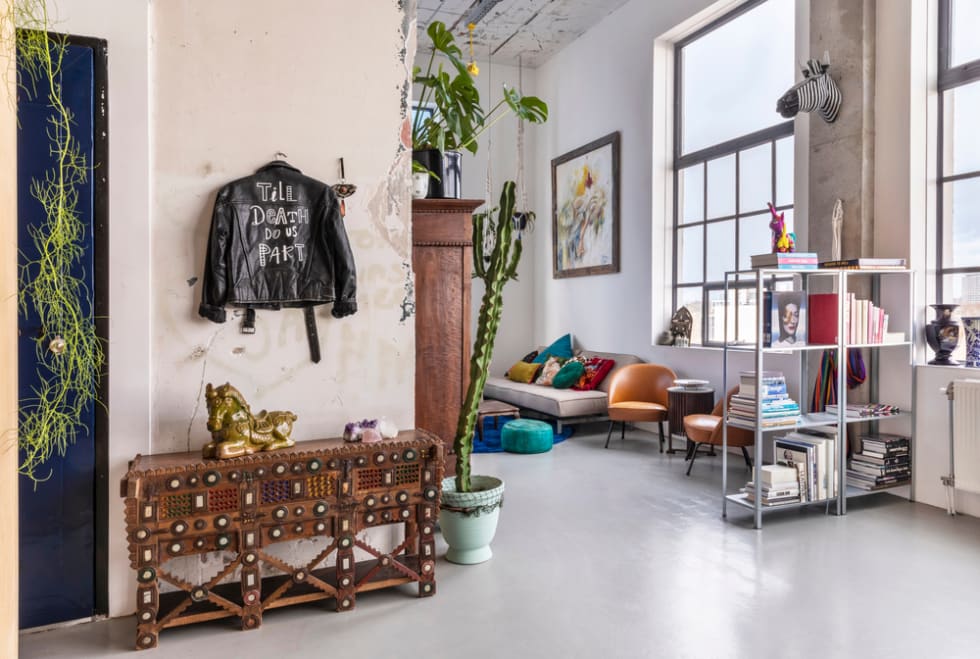 An industrial city loft interior on Strijp S. A spacious, bohemian, modern, mix and match eclectic styled living with colorful details and plants