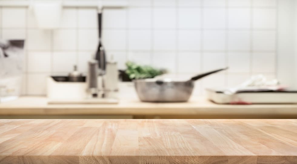 Wood table top on blur kitchen room background .For montage product display or design key visual layout.