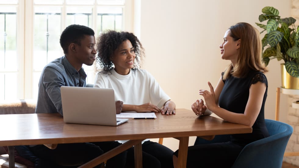 Family taking loan in bank, listening advisor, real estate agent and customers negotiating concept
