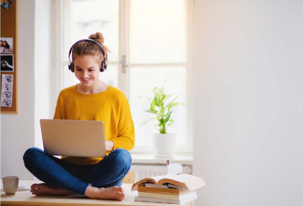 A young female sitting at the table in her own apartment