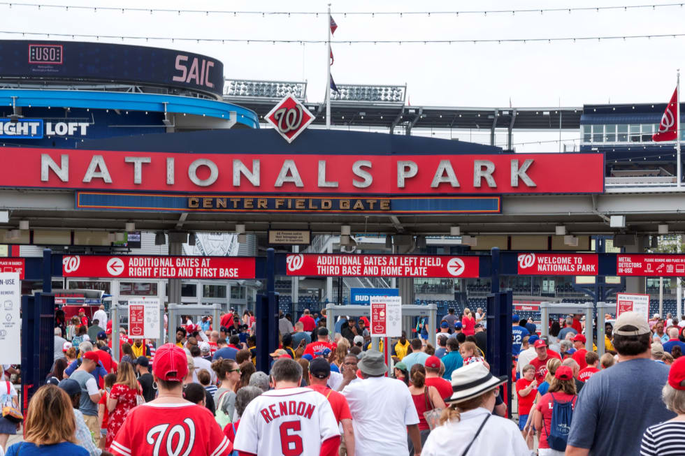 The fans walking into an early morning baseball game between the Nationals and the Met's on the fourth of july- cost of living in washington dc