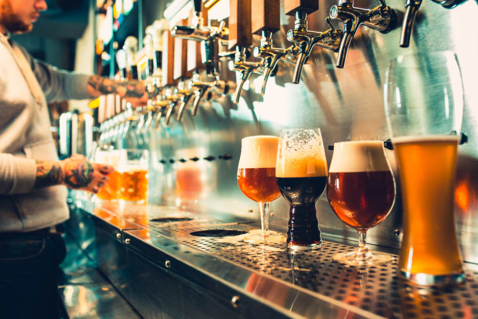 Bartender pouring craft beer at Austin bar 