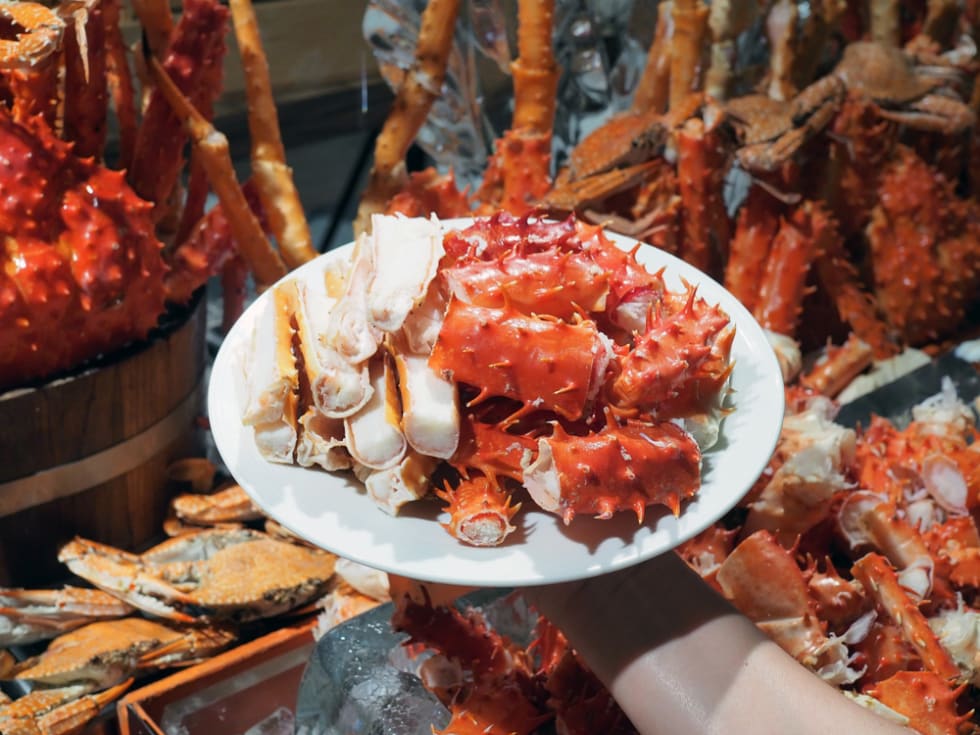 A plate of steamed Alaska king crab (Snow crab) legs. Buffet seafood, lifestyle.