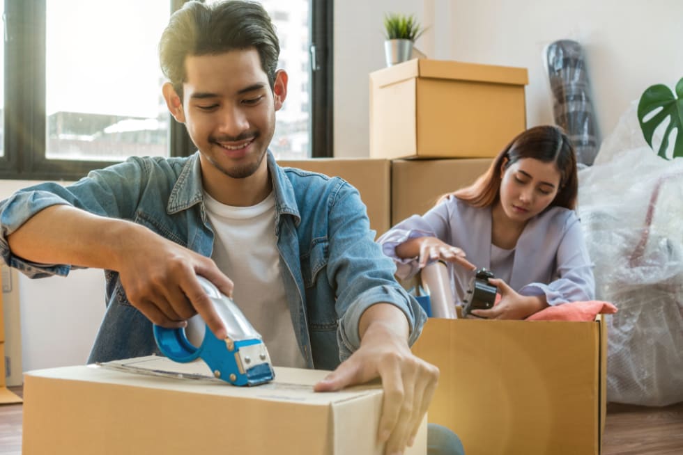 Couple packing moving boxes