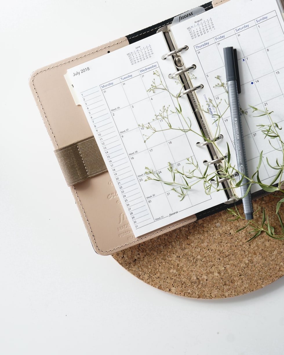 a weekly planner and a pen