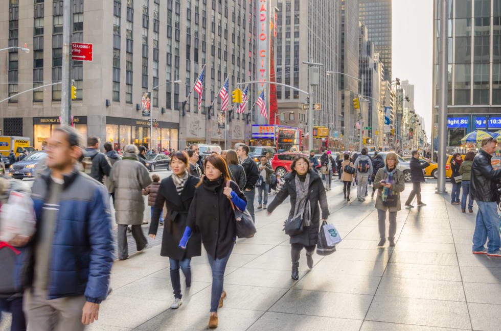 Sixth Avenue in Midtown Manhattan packed with Locals and Tourists during the Christmas Holidays. More than 50 million people visit New York every year.