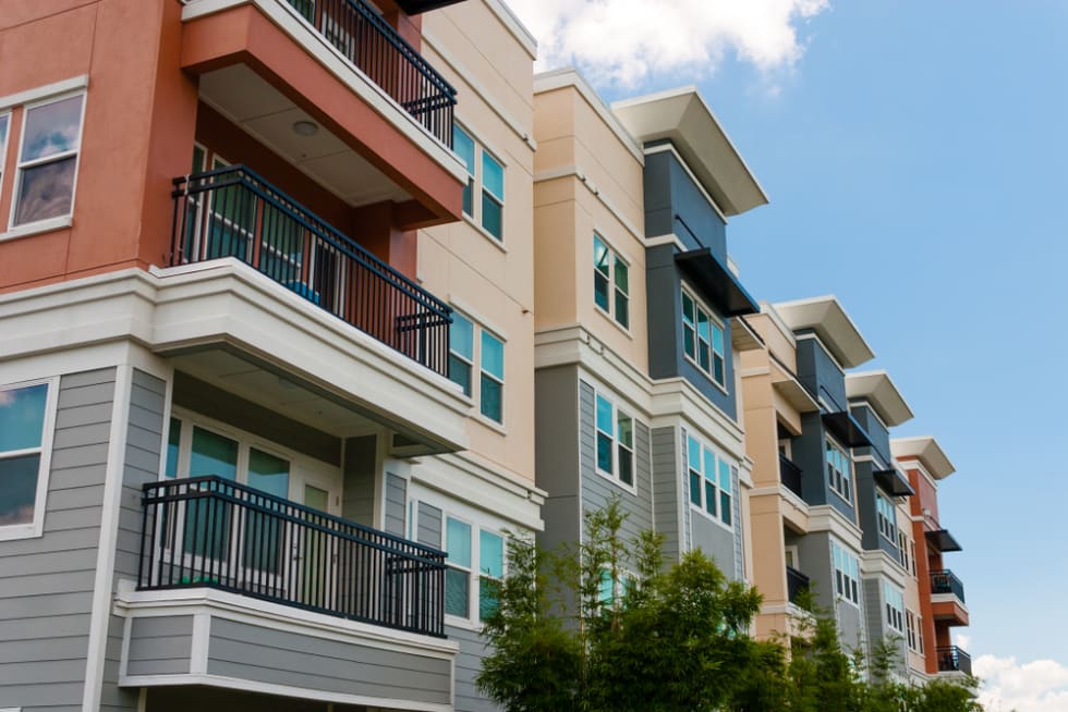  Modern luxury urban apartment building exterior with blue sky.