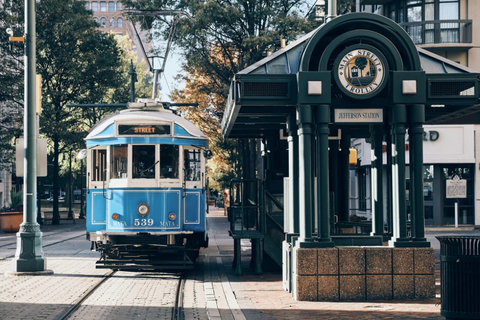 The Main Street Trolley pulls into Jefferson Station on a sunny day in Memphis.