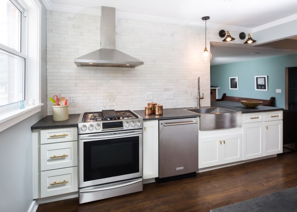 A modern rehabbed galley kitchen with stainless steel appliances and a clean, contemporary look.