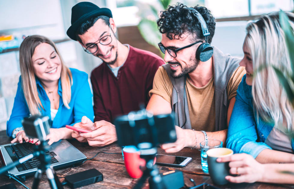 Young friends sharing content on streaming platform with web cam