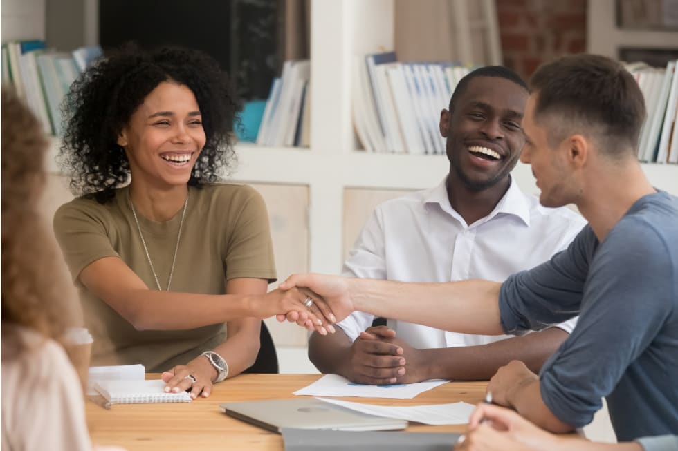  businesswoman handshaking with business partner at meeting, greeting,