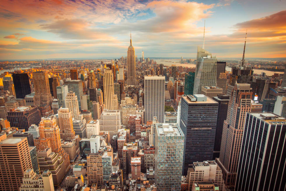  Sunset aerial view of New York City looking over midtown Manhattan towards downtown.