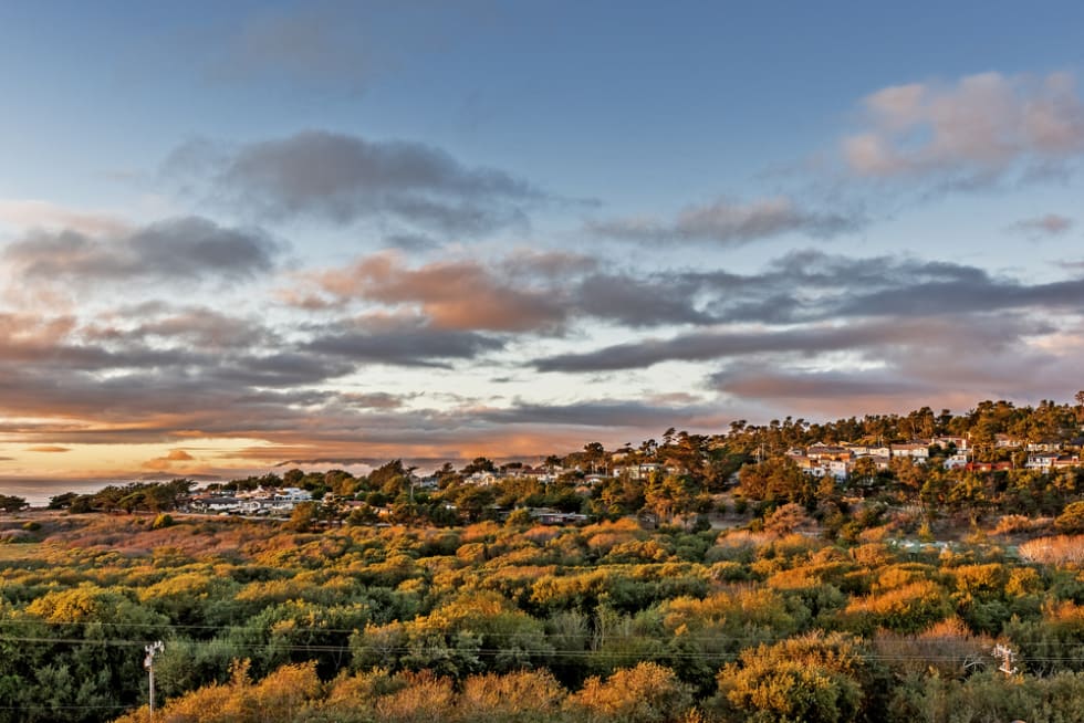 Autumn sunset at Santa Rosa Park estuary Cambria California. In the background you see homes on Happy Hill covered in autumn sunshine.