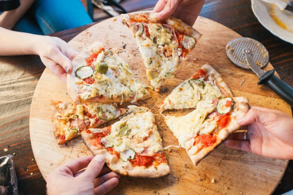 friends eating delicious pizza