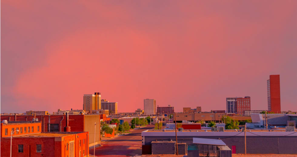 Looking down at the downtown district with a brilliant sunset creating color everywhere in Lubbock, Texas