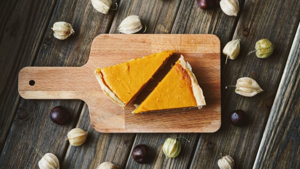 Pumpkin pie slices on wood plank