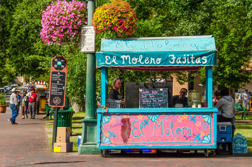 Colorful pink and blue mexican El Molero Fajitas food stand in downtown