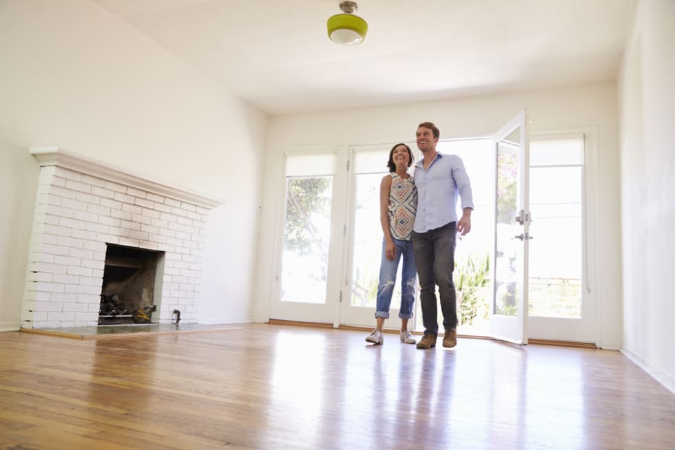 Apartment tour - couple standing in sunny apartment
