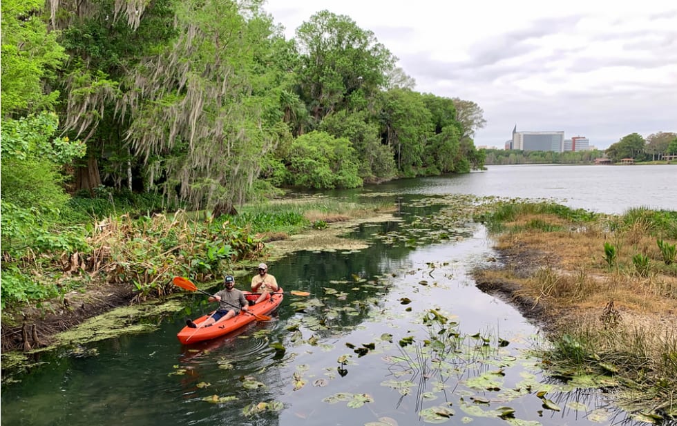 Two men fishing in a red kayak on scenic Lake Rowena