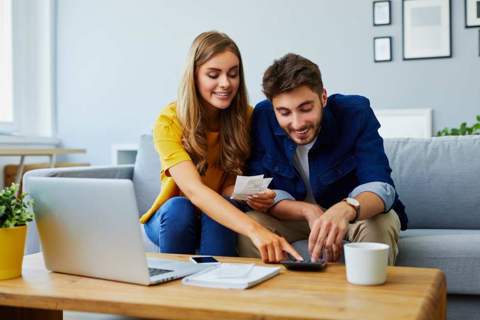 couple paying bills together and managing budget,