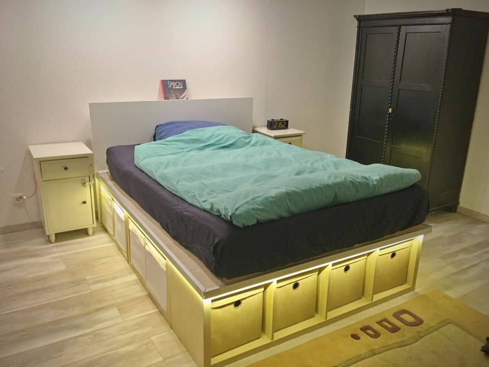 A bed frame with built-in storage using Kallax shelves