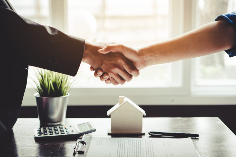 Shaking hands after agreeing on lease agreement terms