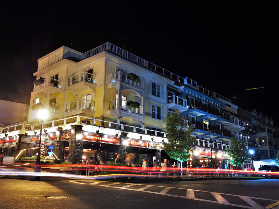 Irish Pub and Restaurant at Night, Bustling scene of tourists enjoying dinner, and traffic going by in front of mixed use building