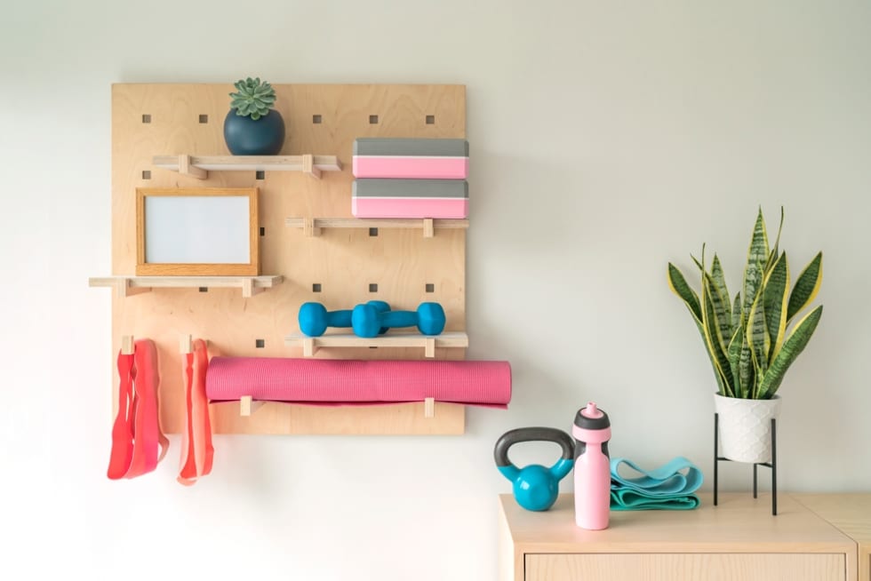 Workout fitness at home gym organized shelves for pilates equipment.