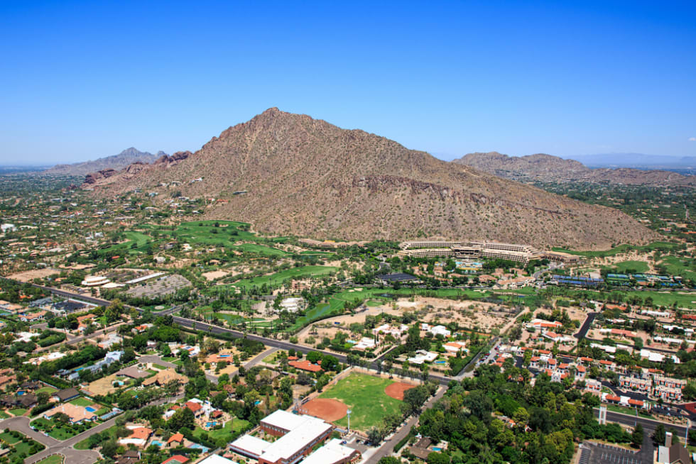 Aerial perspective of exclusive homes and golf course near Camelback Mountain in Phoenix, Arizona