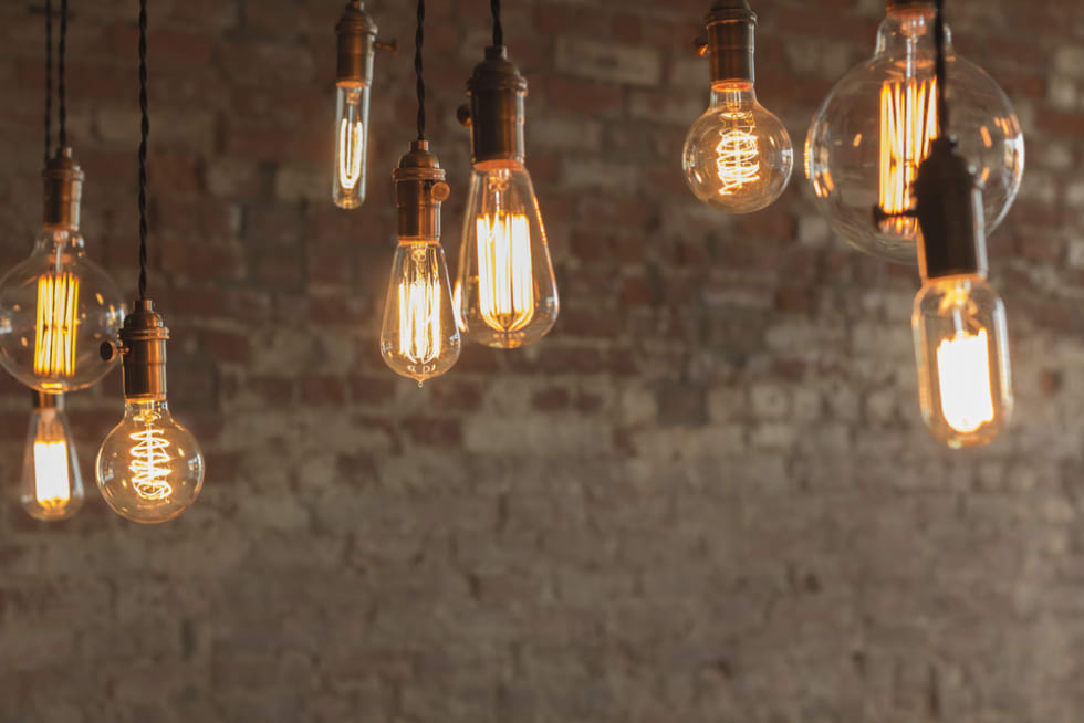  Decorative antique edison style light bulbs against brick wall background