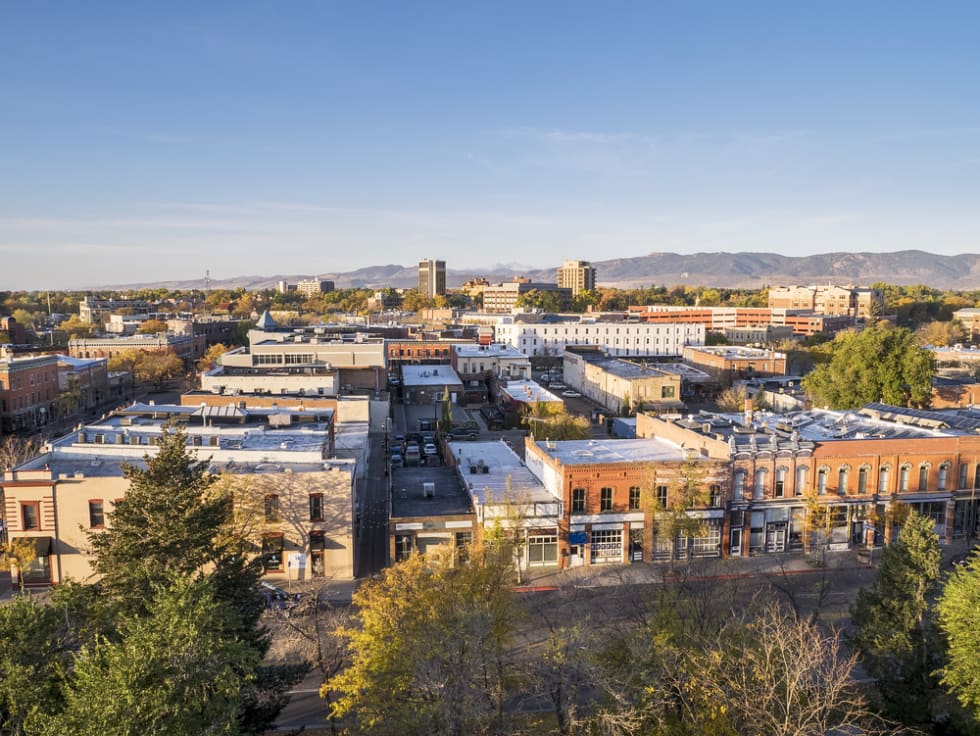  aerial view of Fort Collins downtown in sunrise light, shot from a low flying drone