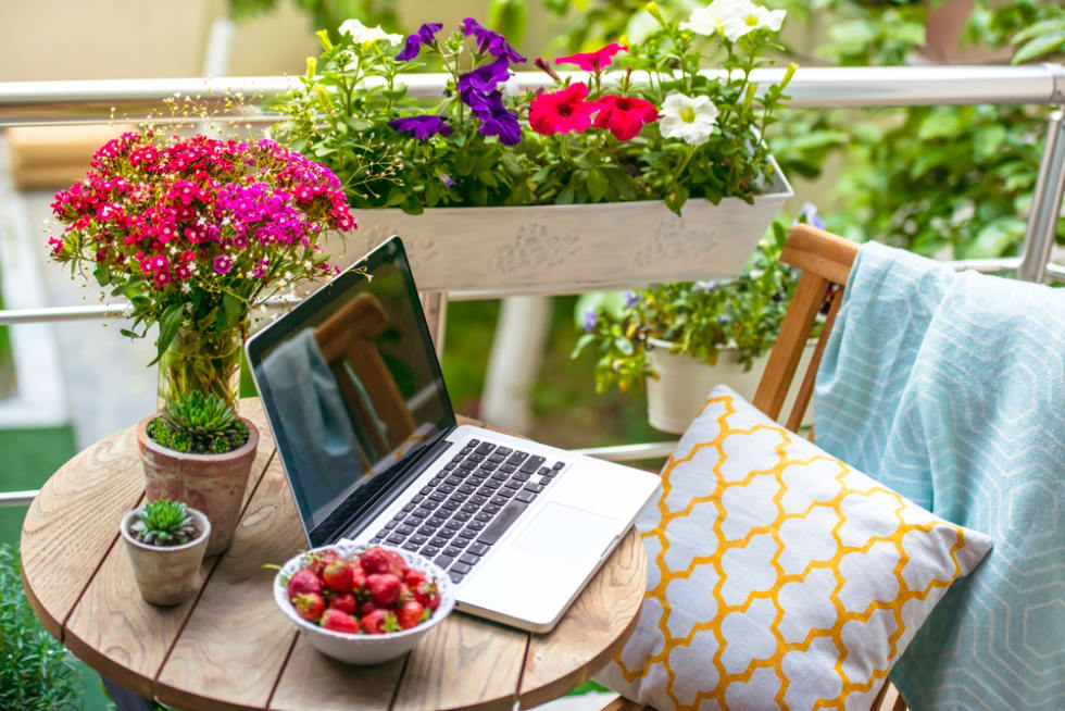Beautiful terrace or balcony with small table, chair and flowers. 
