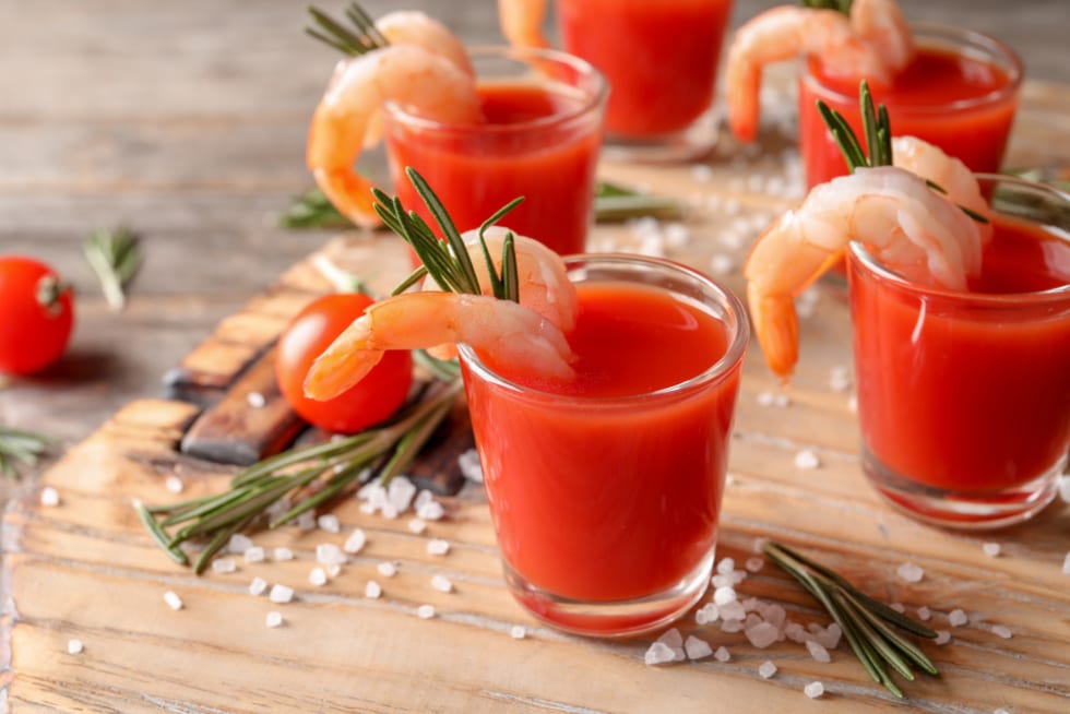 Delicious shrimp cocktail shots on wooden table