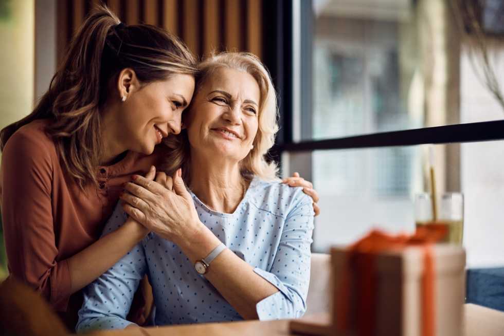 Young woman living with and taking care of senior mother