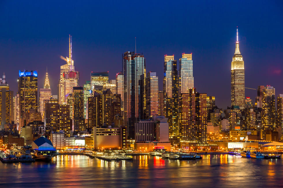 New York City Manhattan midtown buildings skyline at night - cost of living new york