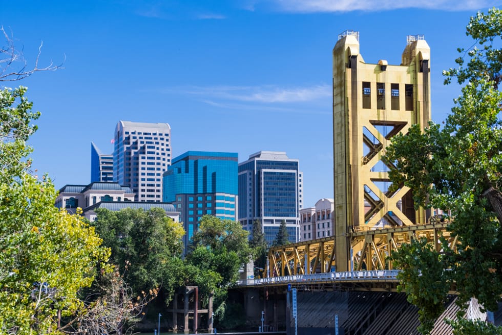  View towards the Tower Bridge and the skyscrapers in downtown Sacramento on a sunny day; California