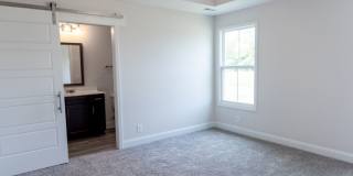 Modern Living Redefined with Stone Fireplace, Gray Cabinetry, Spa Inspired Primary Suite and Covered Outdoor Retreat Gallery 12