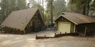 A frame cabin style home with spiral staircase to loft at 16870 Alpine Ln. in Pioneer. Gallery 1