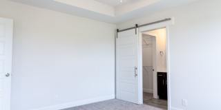 Modern Living Redefined with Stone Fireplace, Gray Cabinetry, Spa Inspired Primary Suite and Covered Outdoor Retreat Gallery 13