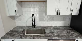 Rare 2-Full Bath Find: Pristine Renovation with Designer En-Suite & Granite Gallery 3