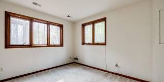 Welcome home! One of a kind, strikingly designed 2-level hillside chalet built on 1 1/2 acres of wooded property with stream surrounded by park land. Gallery 22