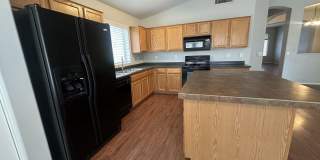 Single-level 3-bedroom home in a desirable Chandler location featuring a 2-car garage and tile roof and wood plank flooring throughout Gallery 15