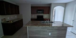 2 car garage with lighting, granite countertops. Backyard includes a custom extended concrete patio perfect for gatherings Gallery 11