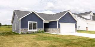 Modern Living Redefined with Stone Fireplace, Gray Cabinetry, Spa Inspired Primary Suite and Covered Outdoor Retreat Gallery 4