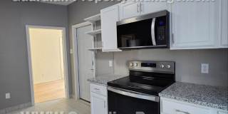 Large main floor duplex unit, Updated Kitchen & Bath, Full Dining Room w/Built-ins + Sunroom, garage stall Gallery 14